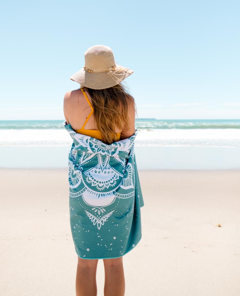 MAHĀNA Mandala beach towel in use – sand-free super absorbent microfibre towel perfect for beach and yoga