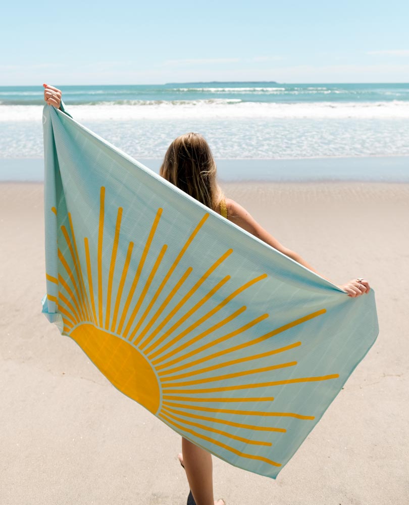 MAHĀNA Sunny Days beach towel in use – sand-free, super absorbent microfibre towel for New Zealand summers